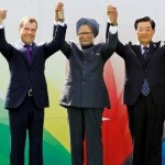 Leaders raise their arms together during the group picture for the BRICS 2012 Summit in New Delhi, India. (AP Photo/Saurabh Das).