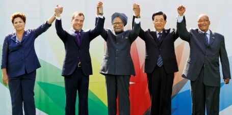 Leaders raise their arms together during the group picture for the BRICS 2012 Summit in New Delhi, India. (AP Photo/Saurabh Das).