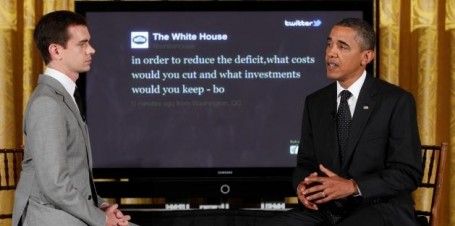 President Barack Obama sits with Twitter co-founder and Executive Chairman Jack Dorsey in front of a screen displaying the question he tweeted during a "Twitter Town Hall". (AP Photo/Charles Dharapak)