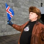 A protestor waves an Icelandic flag outside the Central Bank of Iceland during a demonstration in Reykjavik, Oct. 10, 2008 (AP Photo/Arni Torfason).
